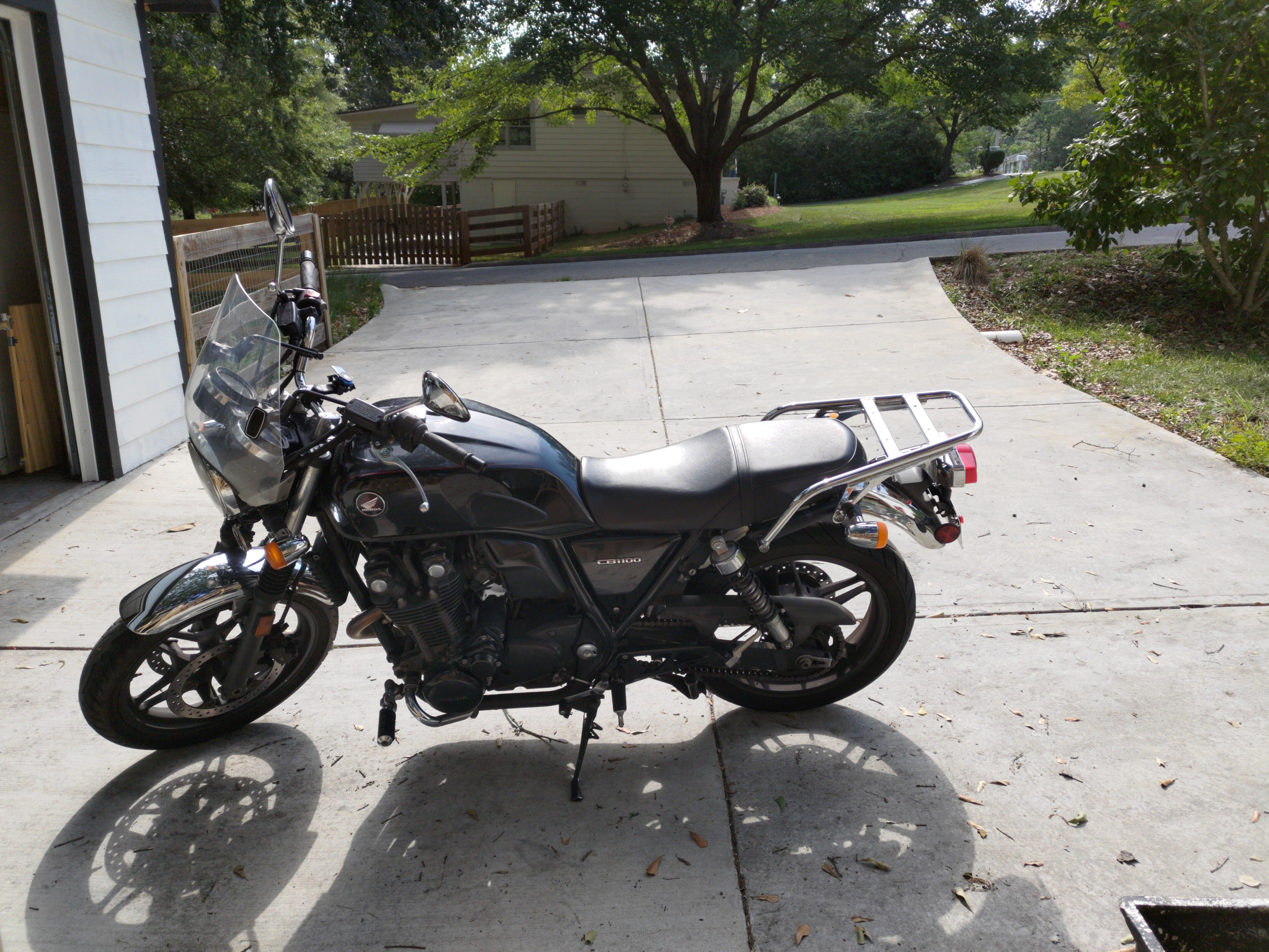 drive side of a Honda CB1100 with a windscreen and luggage rack