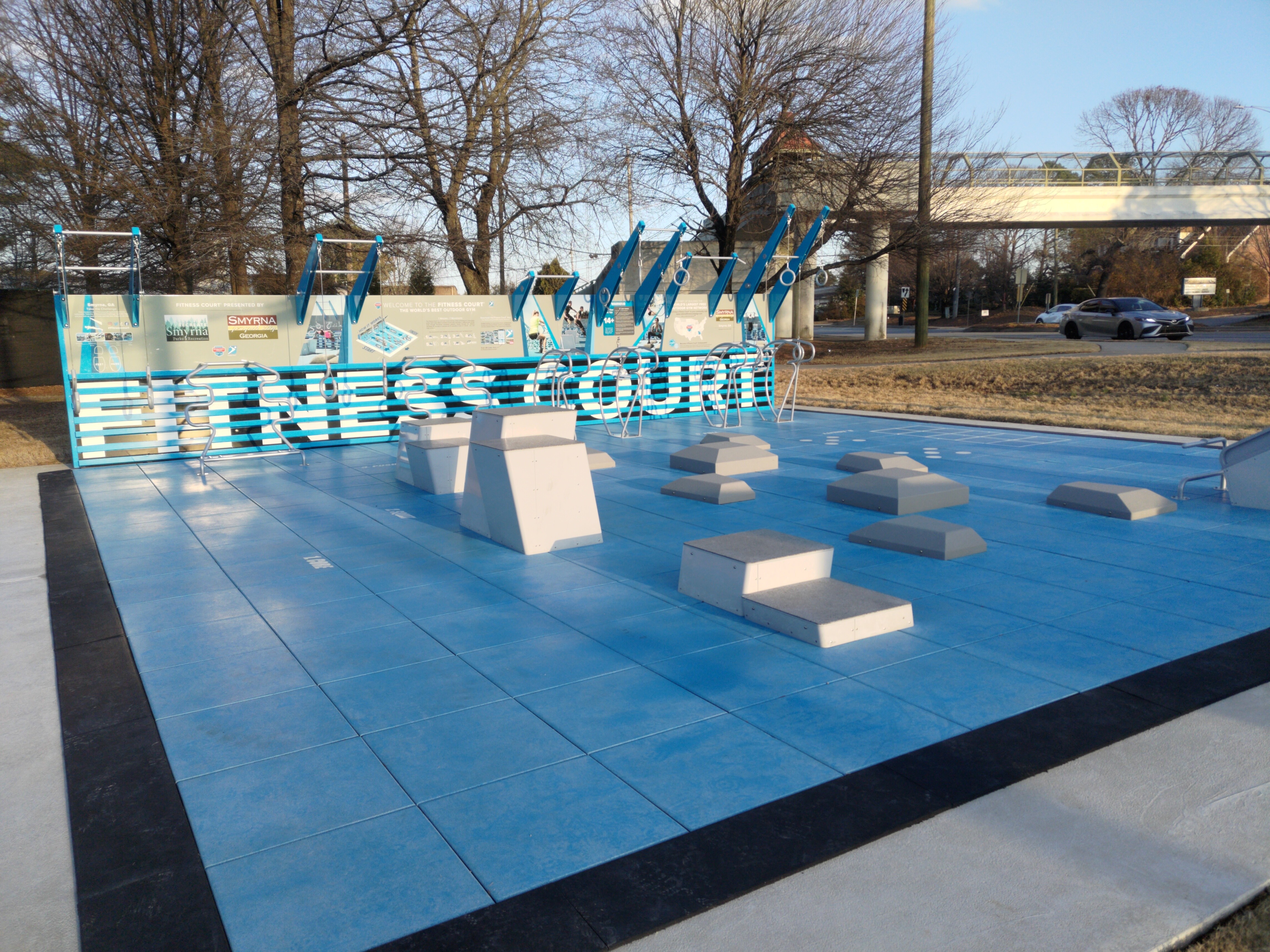 Fitness Court, a square tiled area with various stepping stones and gym equipment