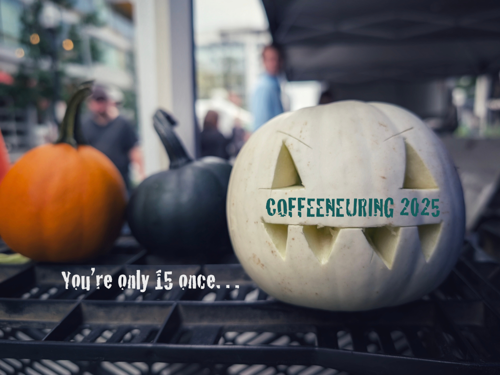 A picture of a white pumpkin with a jack-o-lantern face carved
into it. On the pumpkin the text 'Coffeeneuring 2025' has been printed in a
green, textured, font and next to it are the words 'You're only 15 once‥'
