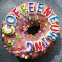 A picture of a white pumpkin with a jack-o-lantern face carved
into it. On the pumpkin the text 'Coffeeneuring 2025' has been printed in a
green, textured, font and next to it are the words 'You're only 15 once‥'